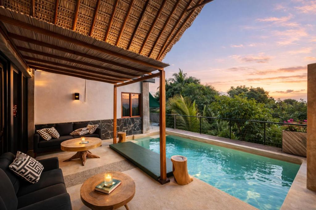 a villa with a swimming pool and a patio at Casa Moorea - Steps to Beach in Puerto Escondido