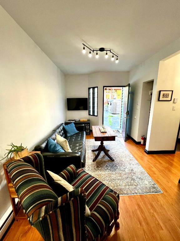 a living room with a couch and a table at The Family Cottage in Delta