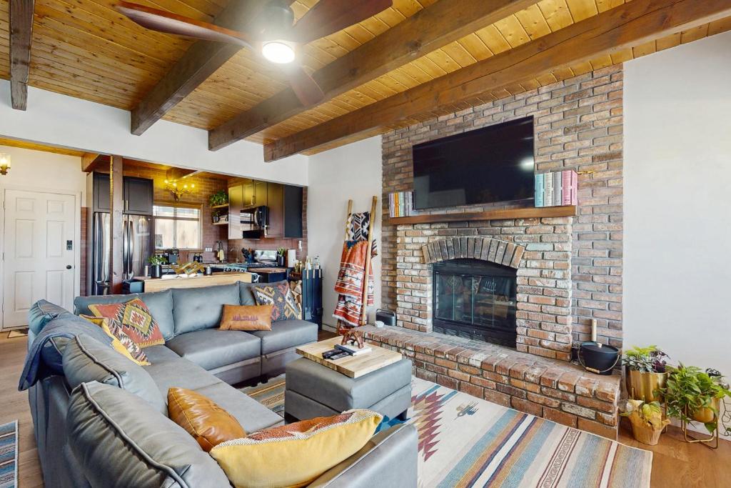 a living room with a couch and a fireplace at Boat, Hike, Fish! Summer Cabin Near Lake Arrowhead in Running Springs