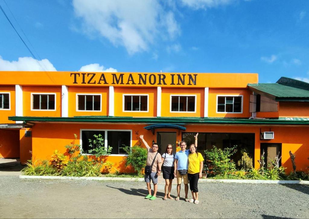 a group of people standing in front of a building at Tiza Manor Inn in Roxas City