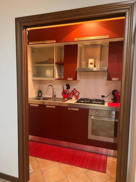 a kitchen with brown cabinets and a sink at La Petite Maison Rieti in Rieti