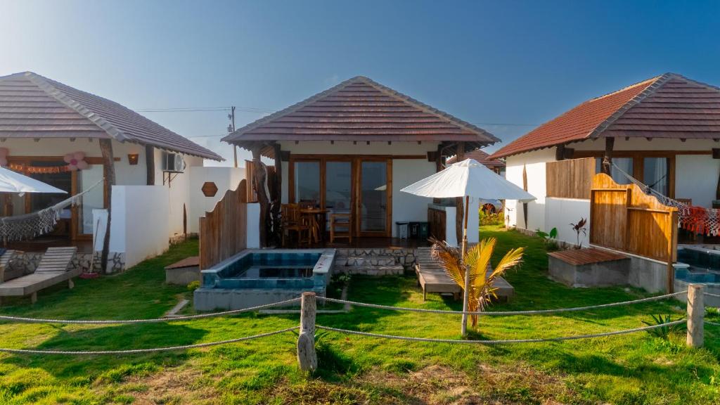 a group of houses with a yard with a pool at Primaluna Romantica in La Punta de los Remedios
