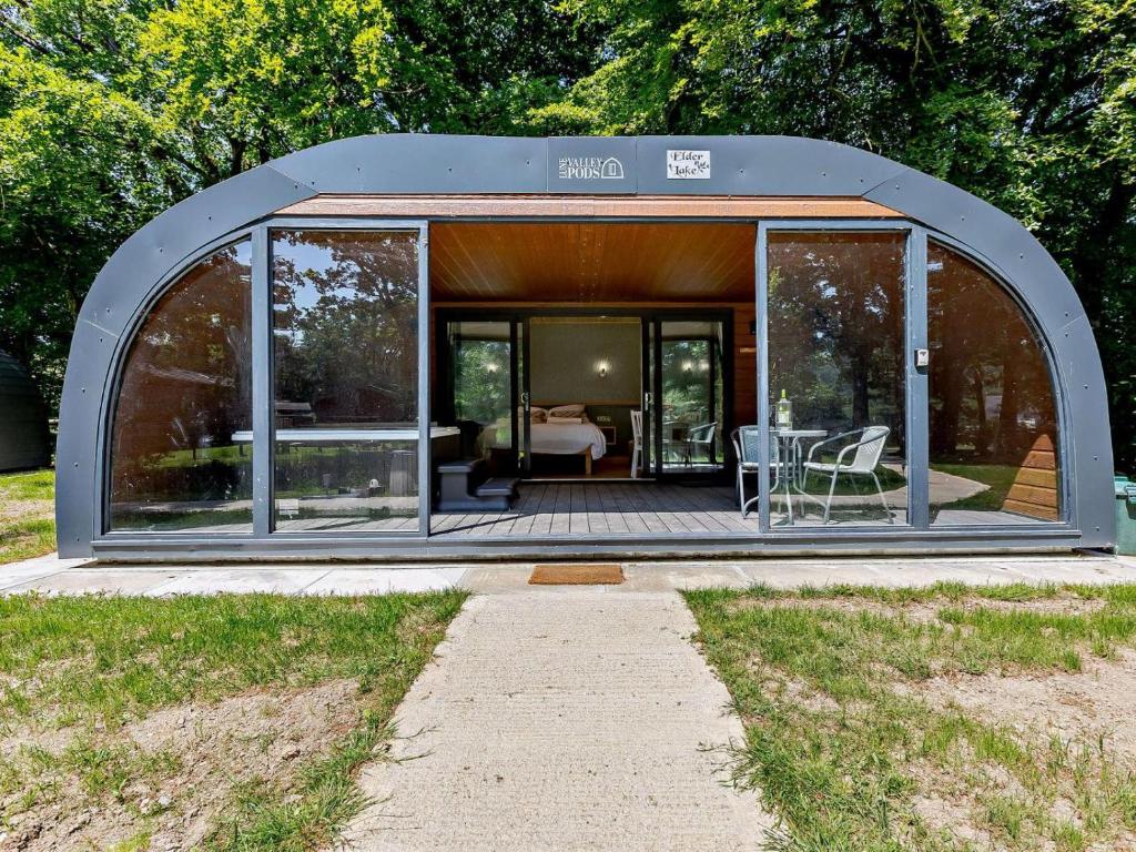 a large glass house with a table in it at 1 Bed in Okehampton oc-92384 in Okehampton