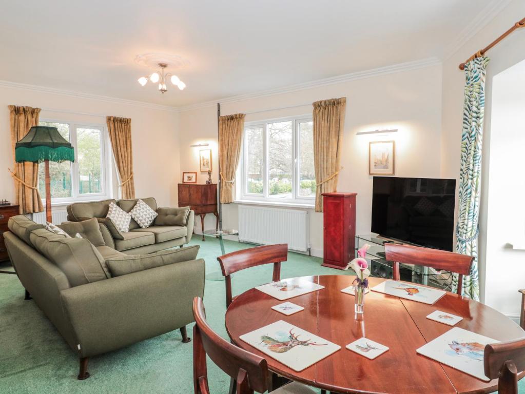 a living room with a table and a couch at The Flat House in Taunton