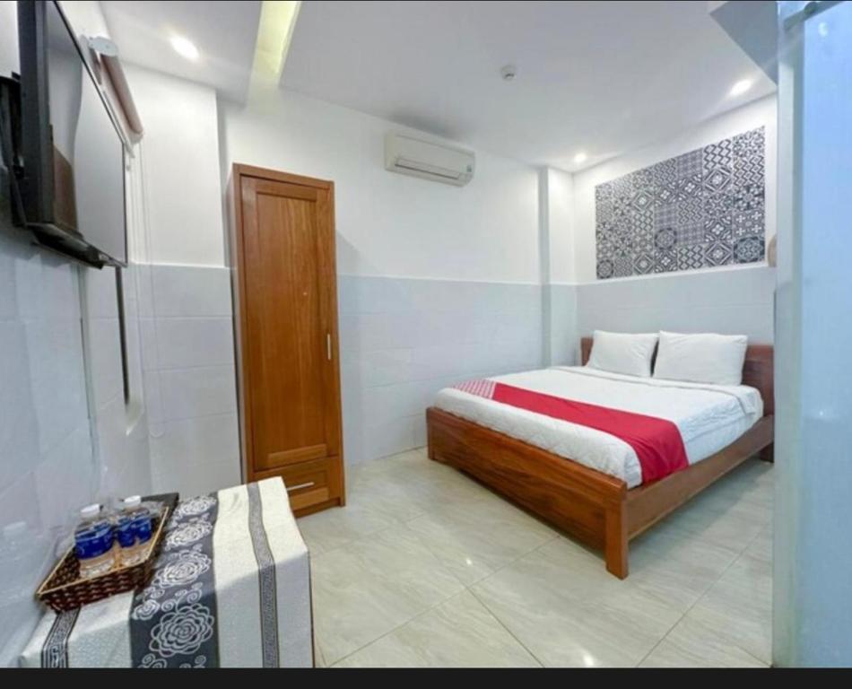a small bedroom with a bed and a television at Tây Nguyên hotel Đà Nẵng in Danang