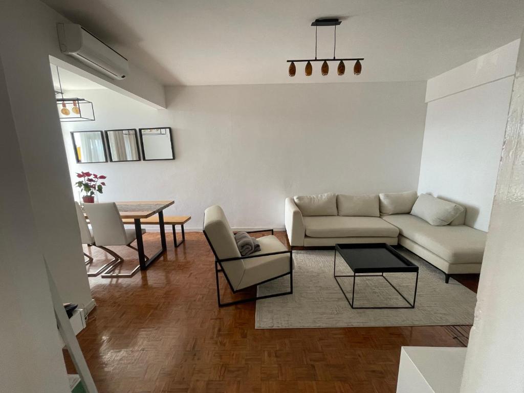 a living room with a couch and a table at AP Museu Maputo in Maputo