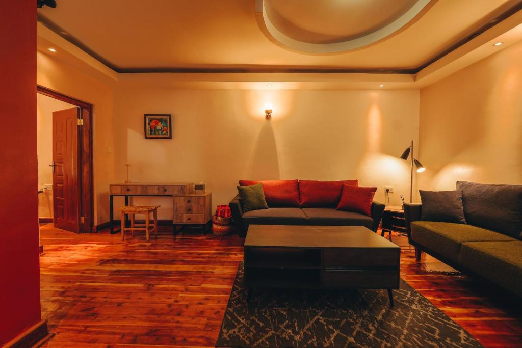 a living room with a couch and a table at Tano Bora Hotel in Sekenani