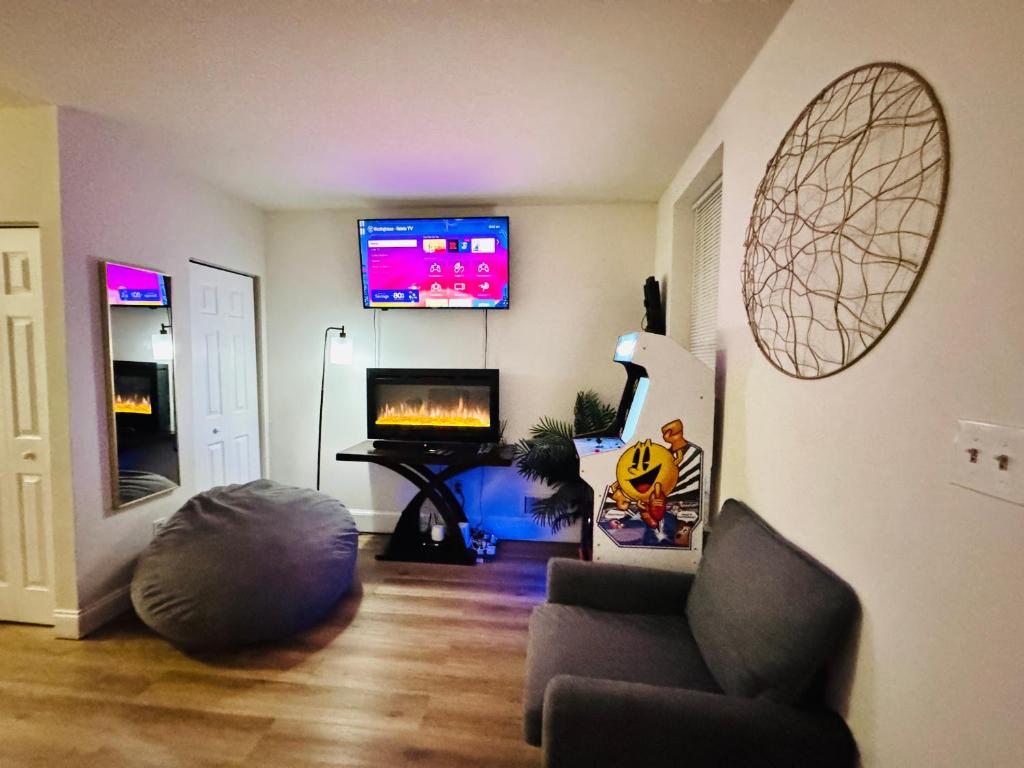 a living room with a couch and a flat screen tv at Downtown Home - Close to Topgolf, Ravens Stadium, Orioles Park, UM Baltimore in Baltimore