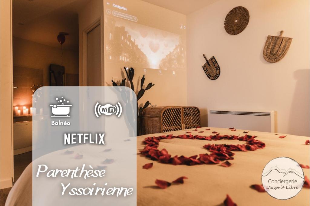 a sign with a heart made out of roses on a bed at La Parenthèse Yssoirienne - Balnéo - Vidéoprojecteur in Issoire
