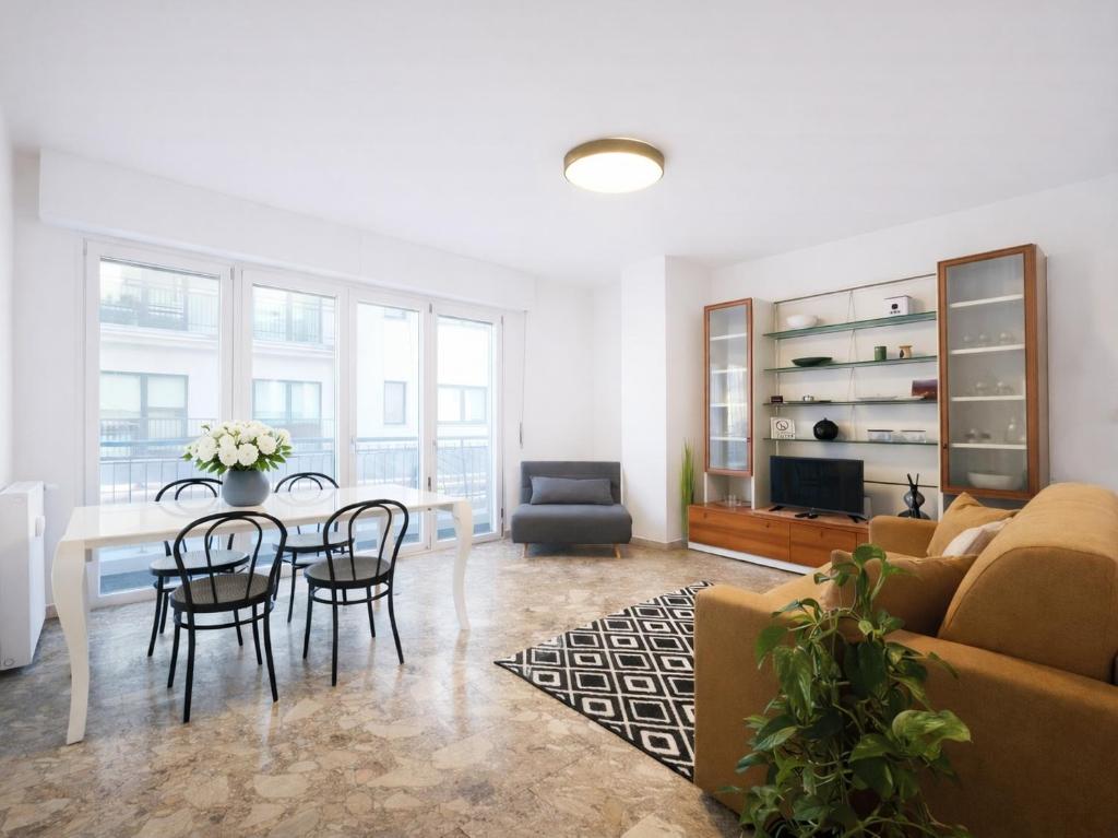 a living room with a couch and a table and chairs at Bella Vita Stays Happy in Sondrio