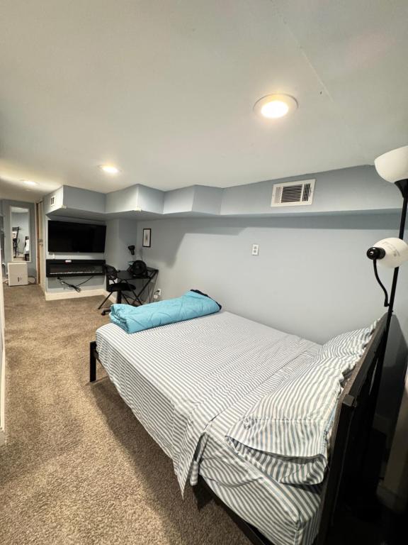a bedroom with a bed and a desk in a room at Downtown Suite - Close to Topgolf, Horseshoe Casino, UM Baltimore in Baltimore