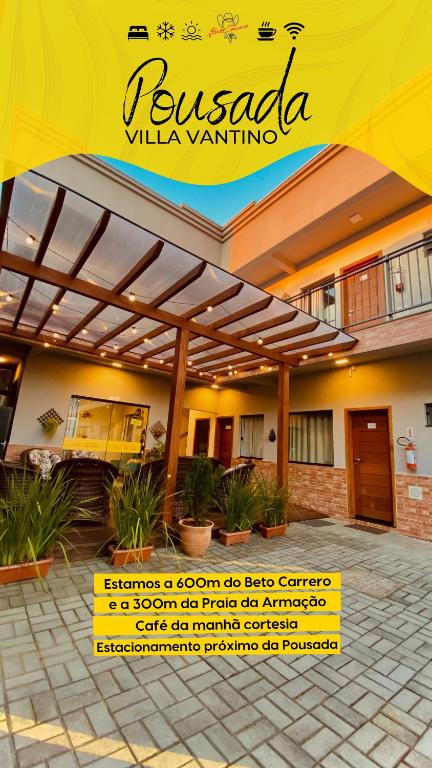 a building with a yellow sign in front of it at Pousada Villa Vantino in Penha