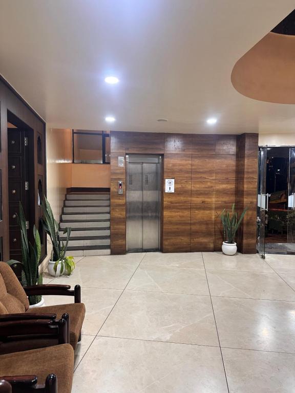 a lobby with a door and some plants at Hotel Gul-bahar in Satara