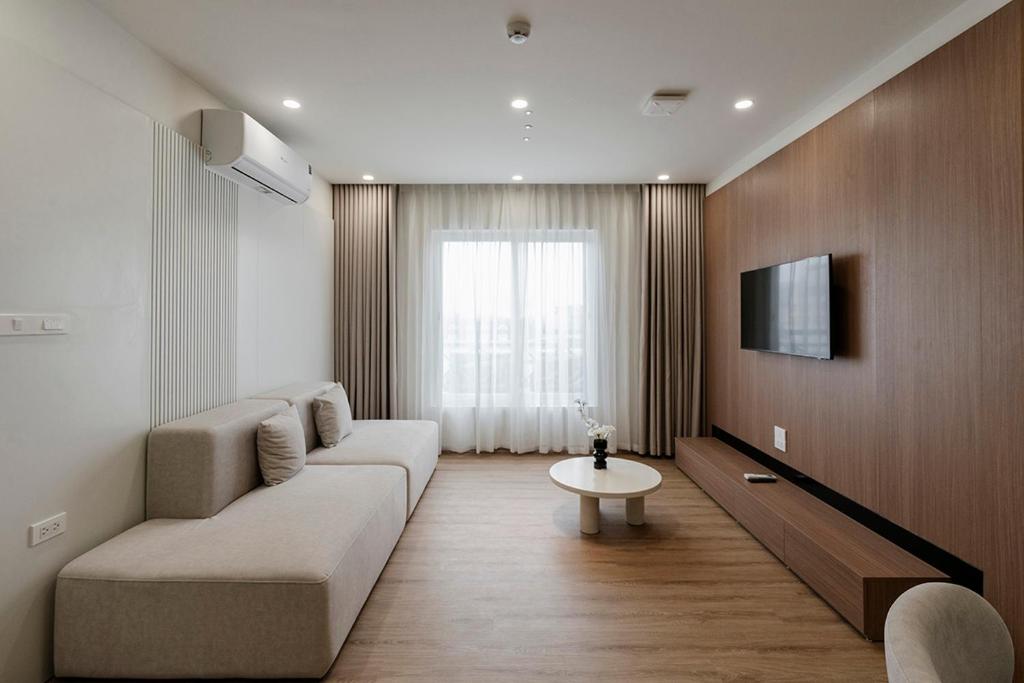 a living room with a couch and a tv at Residences A-25 in Hanoi