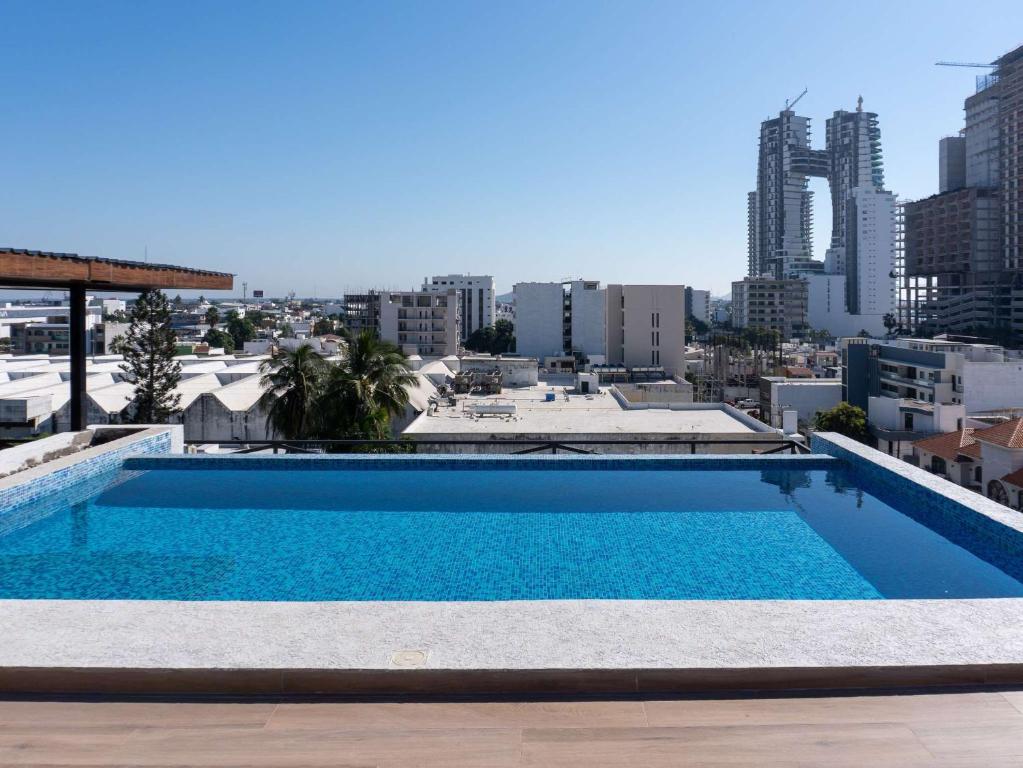 a swimming pool on the roof of a building at Rooftop Pool & Steps to the Beach in Mazatlán