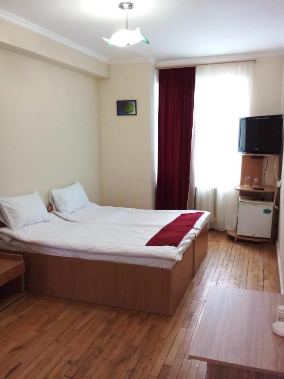 a bedroom with a large bed in a room at NR Rest House in Tsaghkadzor
