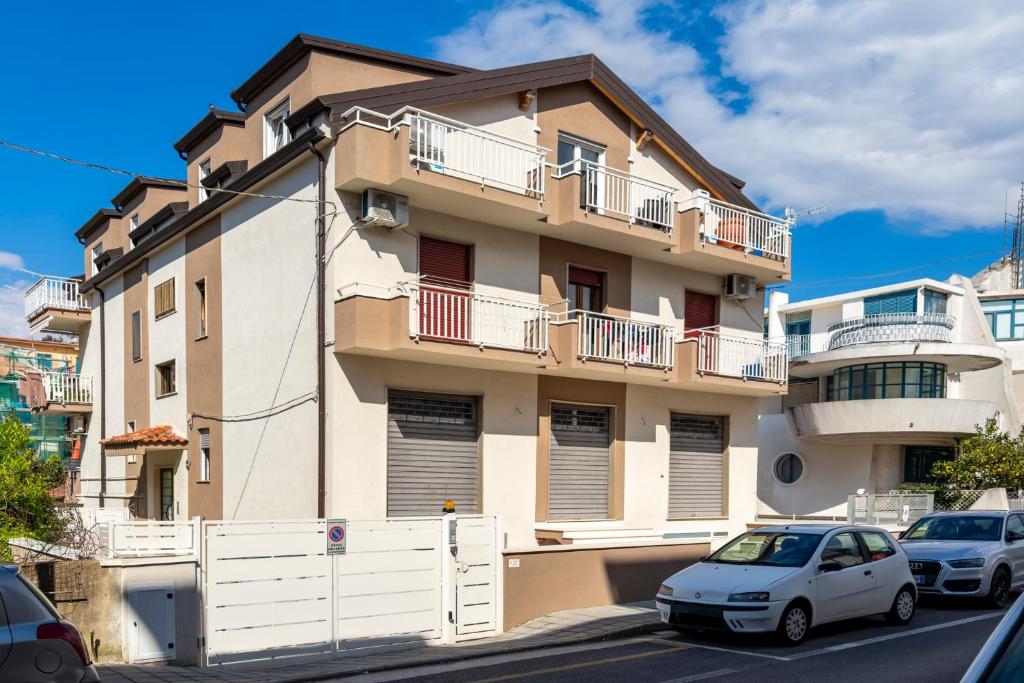 a white car parked in front of a building at Cilento Sea Rooms in Agropoli