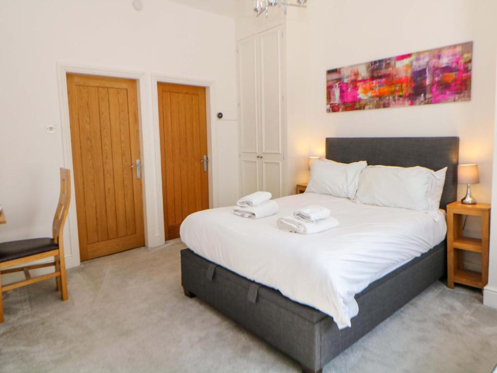 a bedroom with a bed with two towels on it at Lumsdale in Matlock