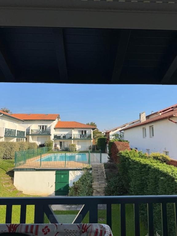 a view from a balcony of a house with a pool at Studio dans résidence avec piscine in Bidart