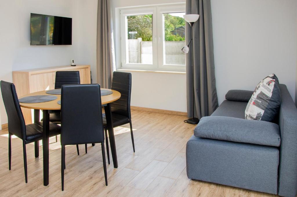 a living room with a table and a couch at Apartamenty Suchacz in Suchacz