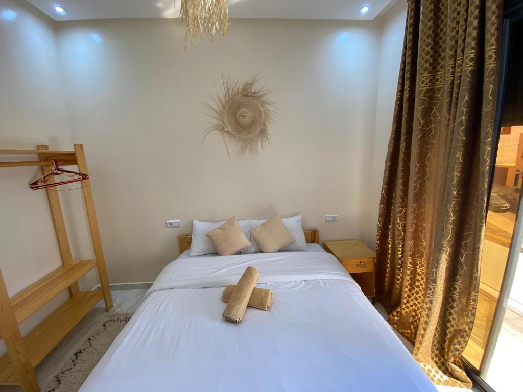 a bedroom with a bed with a teddy bear on it at Atlantic Coast Imsouane in Imsouane