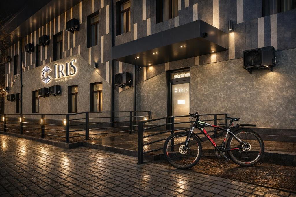 a bike parked in front of a building at night at Iris Hotel Tashkent in Salor Bekati