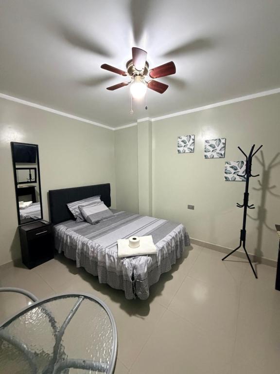 a bedroom with a ceiling fan and a bed at Estancia La Luna in Huarmey