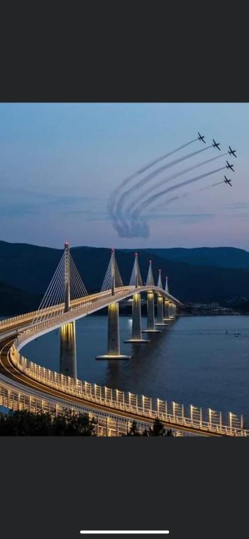 a group of planes flying over a bridge over water at Villa Ante Blace in Blace