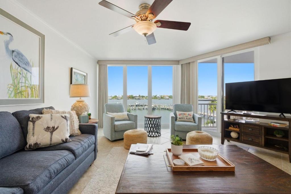 a living room with a couch and a flat screen tv at SeaSpray Riverside 312 in Perdido Key