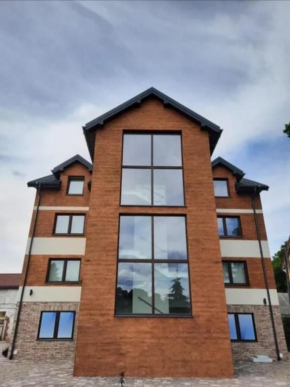 a tall brick building with windows at Apartamenty Mazurska Strefa in Pisz
