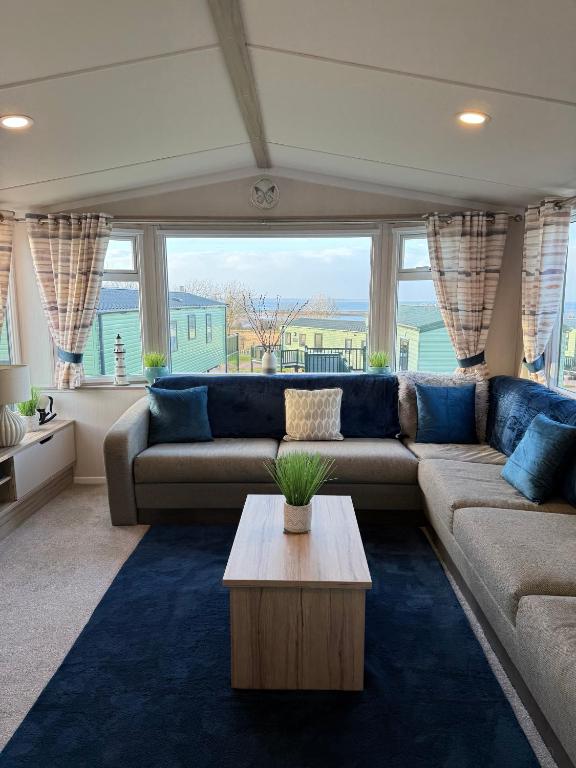 a living room with a couch and a table at Beach View Eden Heights Kinkell Braes 2 bedrooms 2 bathrooms in St. Andrews