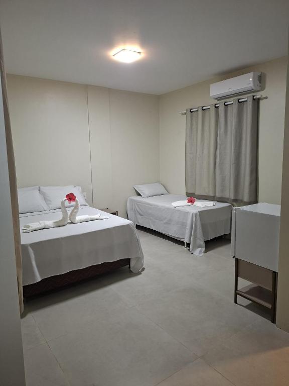 a room with two beds in a room at Pousada Breizh Brasil Lençois - BBL in Barreirinhas
