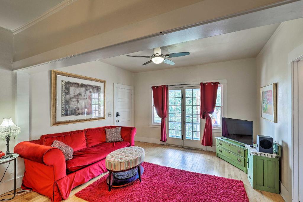 a living room with a red couch and a tv at Walkable Group Getaway in Bisbee: 4-Unit Bundle! in Bisbee