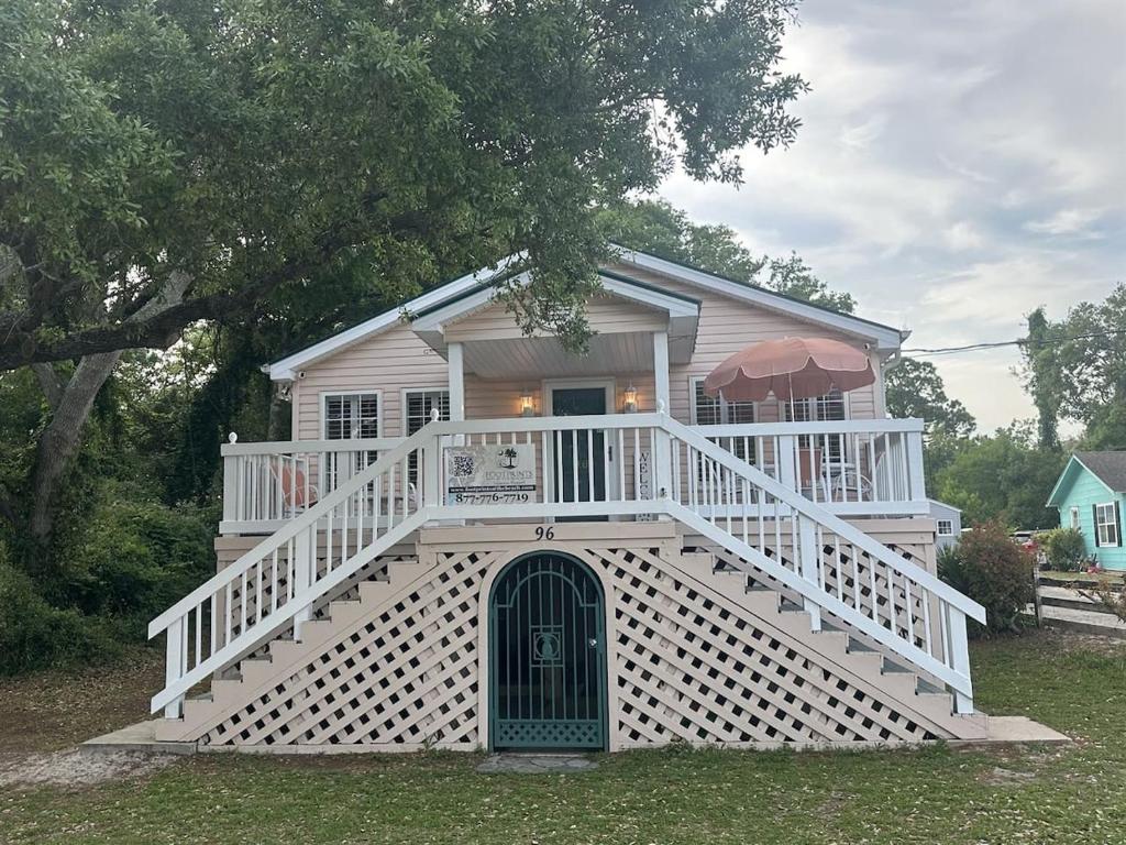 a large white house with a large front porch at Just Peachy in Myrtle Beach
