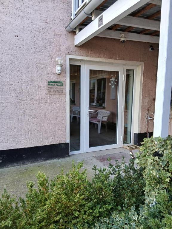 a sliding glass door on a house with a patio at Landhotel Eisdorf in Eisdorf
