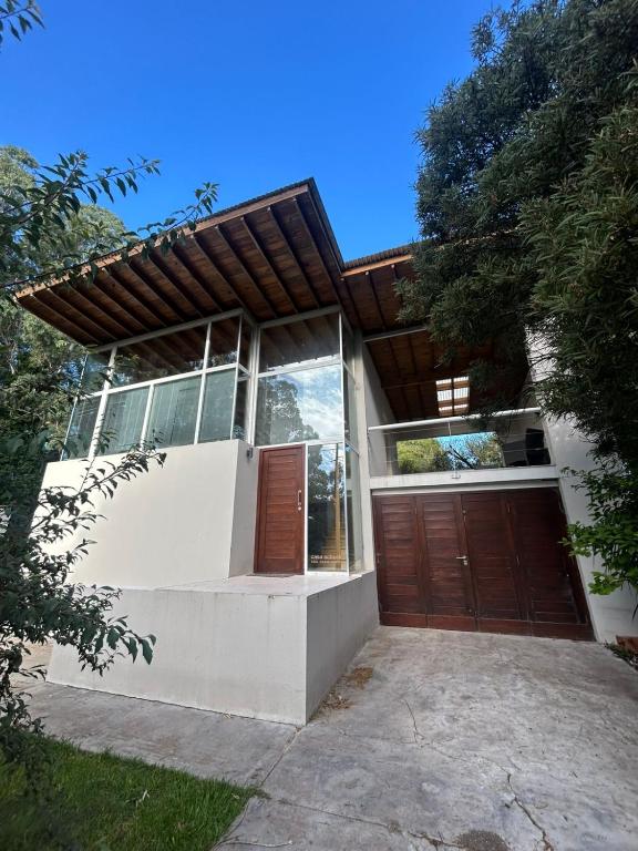 a house with a garage and a wooden door at Seamount Design in Mar del Plata