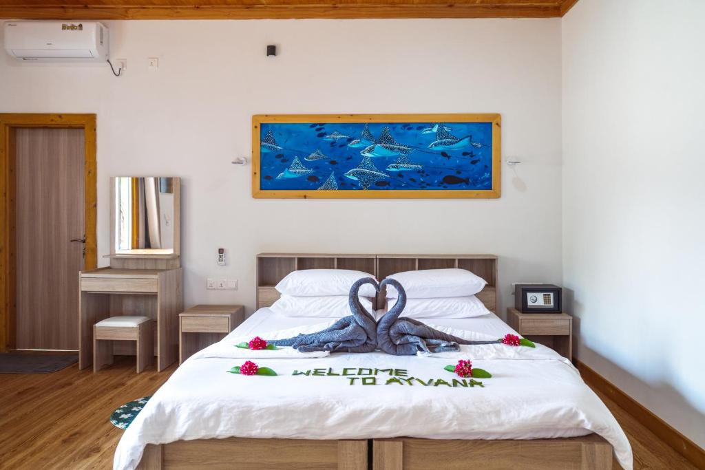 a bedroom with a bed with an octopus on it at Ayvana Retreat in Feridhoo