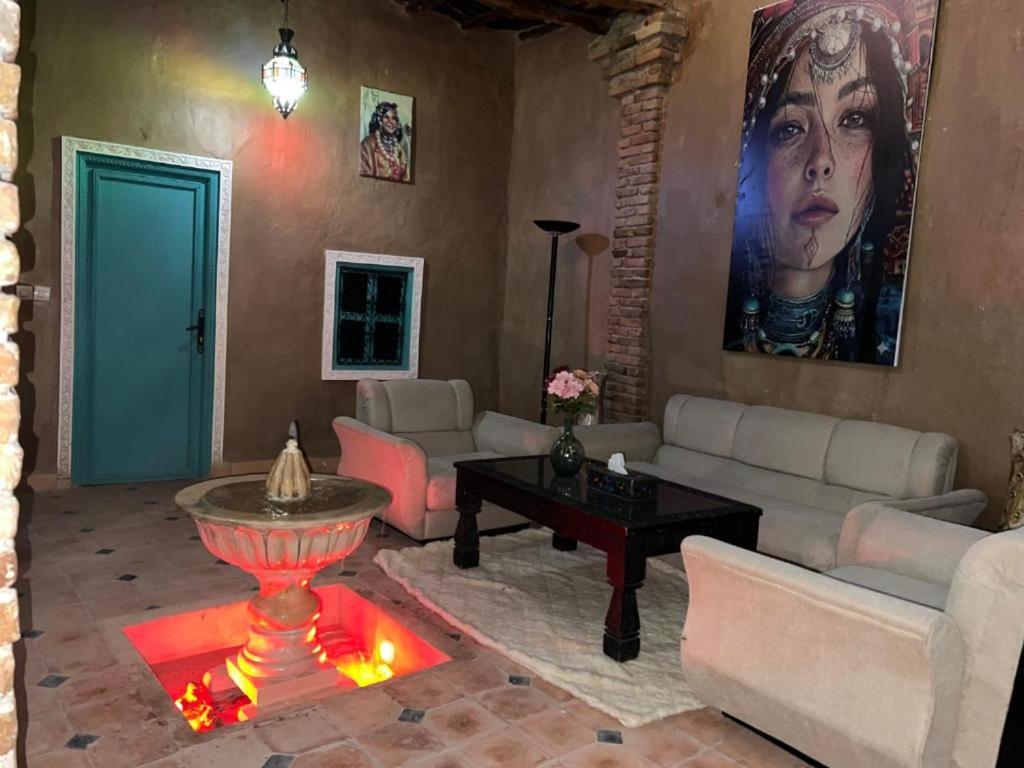 a living room with a couch and a table at Riad dar khadija in Taroudant