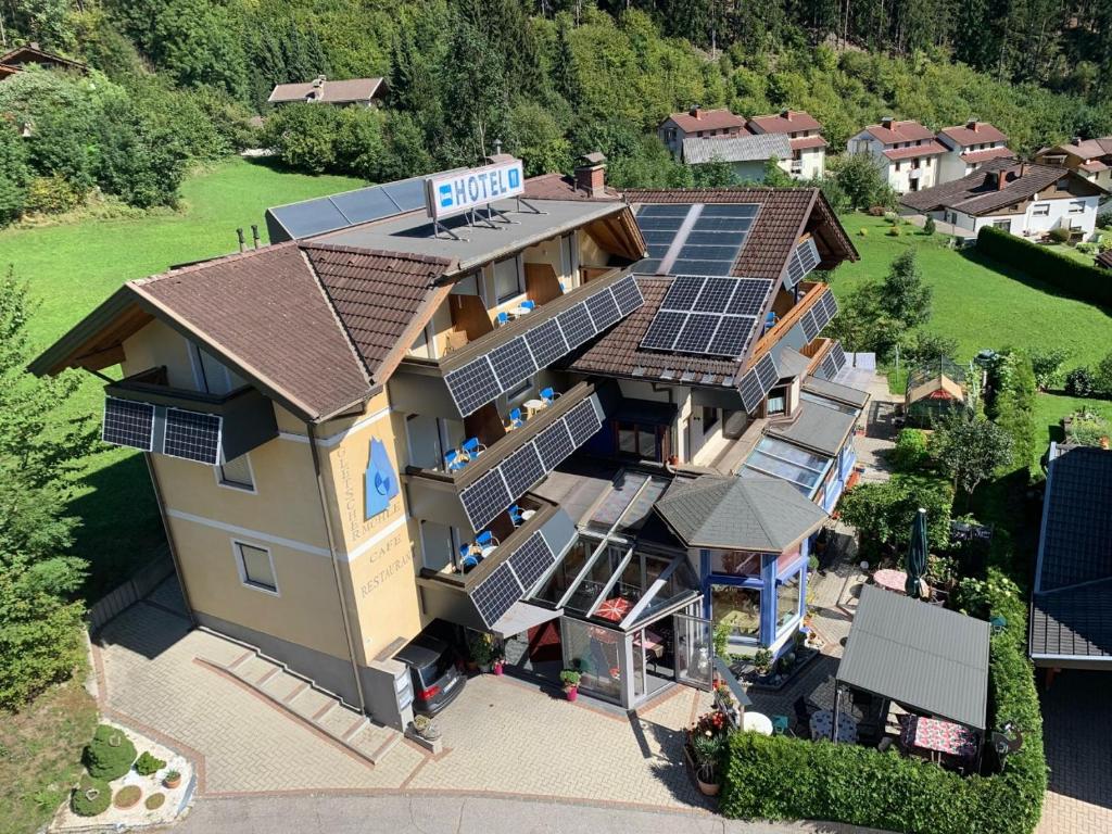 an aerial view of a house with solar panels on its roof at Hotel Gletschermühle in Flattach