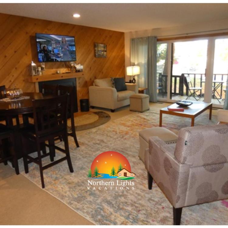 a living room with a couch and a table at Courtside Condo at Summit in Bellaire