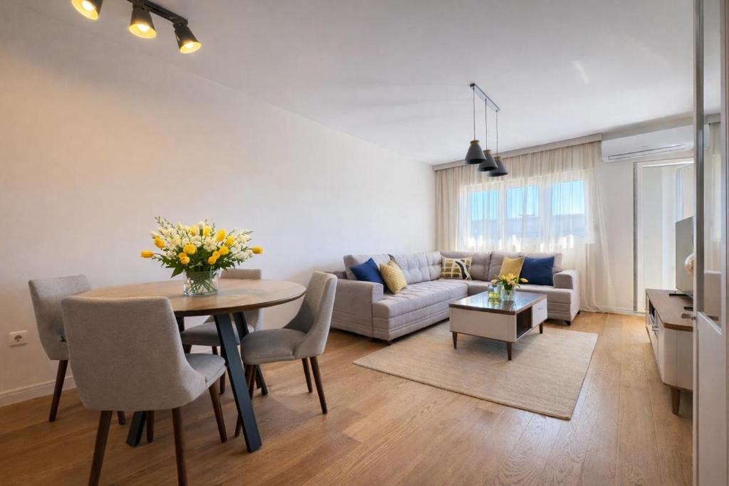 a living room with a table and a couch at Premium Rent Podgorica in Podgorica