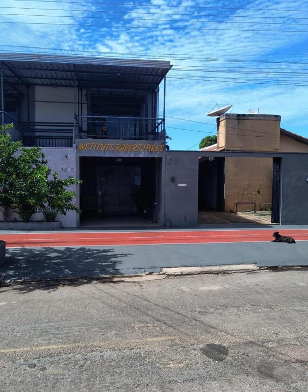 a building with a sign on the side of a street at Espaço Pires in Jaciara