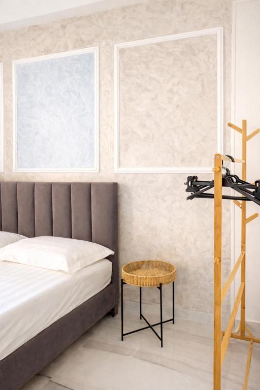 a bedroom with a bed and a cross on the wall at Thea Rooms in Himare