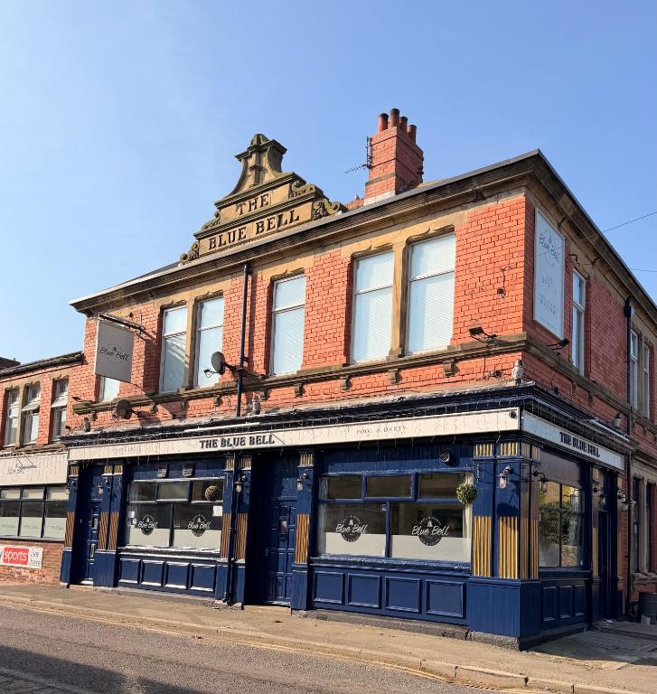 an old brick building on the corner of a street at The Blue Bell Inn in Amble