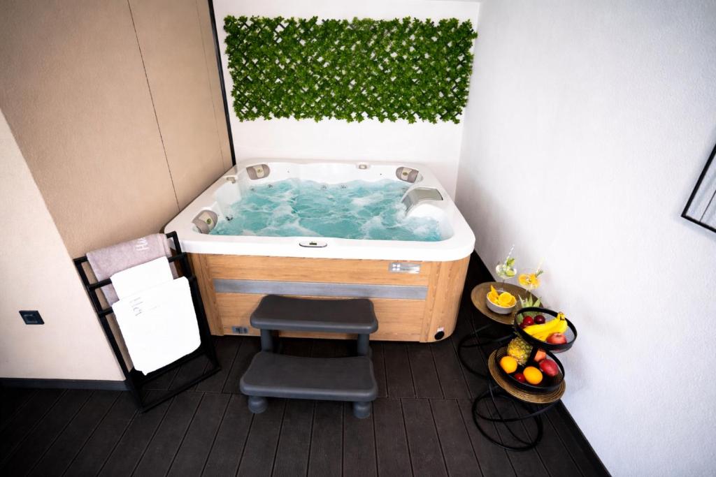 a bathroom with a jacuzzi tub with a chair at AC Ivona - Mobile home AURORA Vodice in Vodice