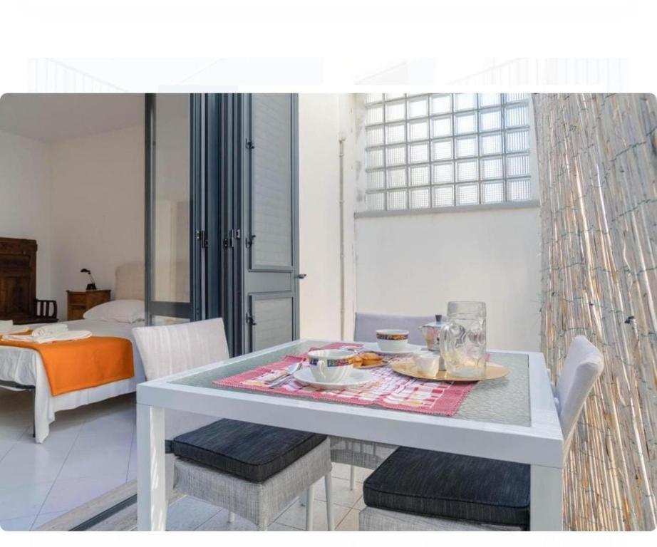 a table and chairs with a tray of food on it at Otranto City Center - Steps from the Beach in Otranto