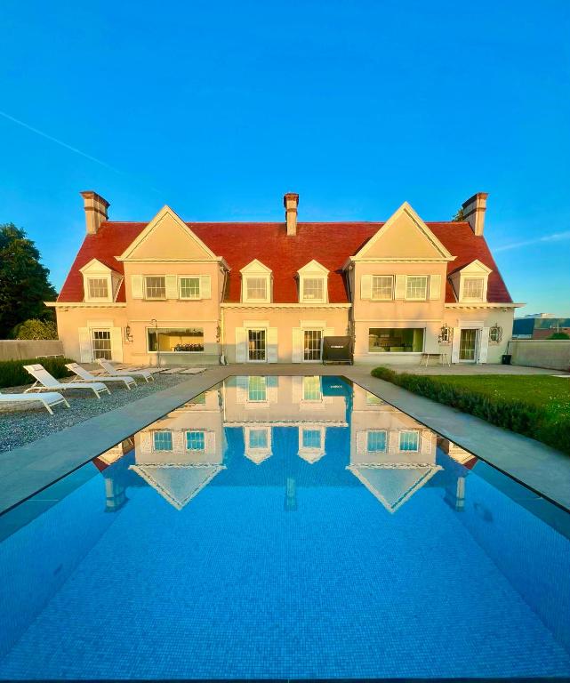 a large house with a swimming pool in front of it at Luxury Villa Pool & Spa in Halle