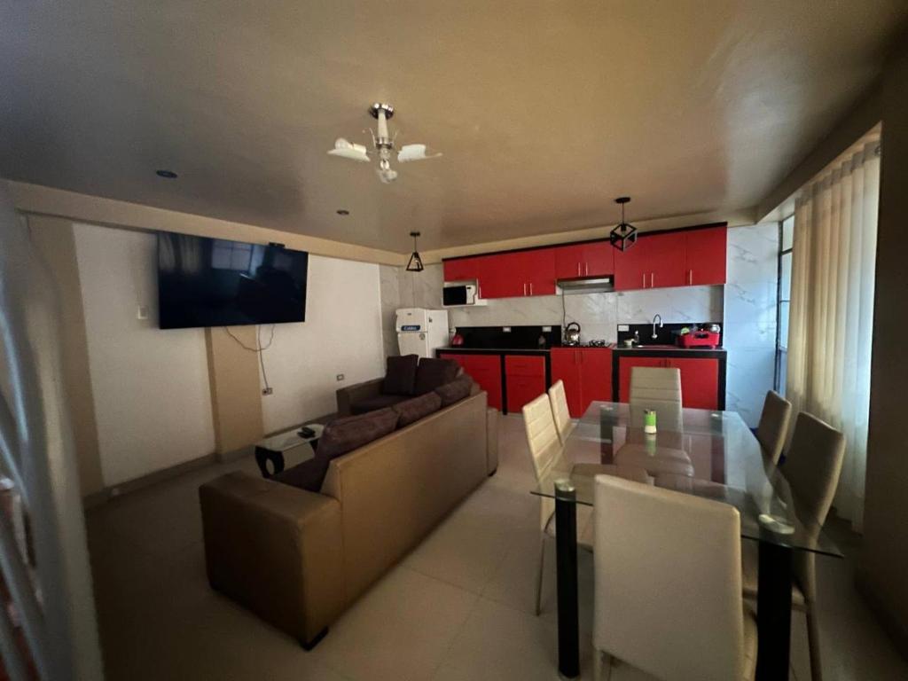 a living room and kitchen with a table and a couch at Domi ApartHotel , first floor and duplex in Cusco