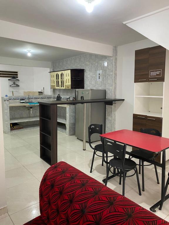 a large kitchen with a red table and chairs at Apto Albor Blanco in Popayan