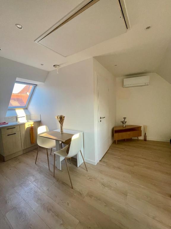 a dining room with a table and chairs in a room at - Le 4ème Tourbillon- in Molsheim
